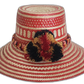 Handmade Wayuu straw hat with red tribal weave and red-black-gold pompoms