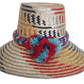 Handmade Wayuu straw hat with red, navy, and gold patterns and colorful pompoms