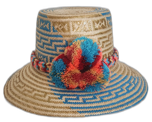 Handmade Wayuu straw hat with sky blue tribal pattern and bright pompoms