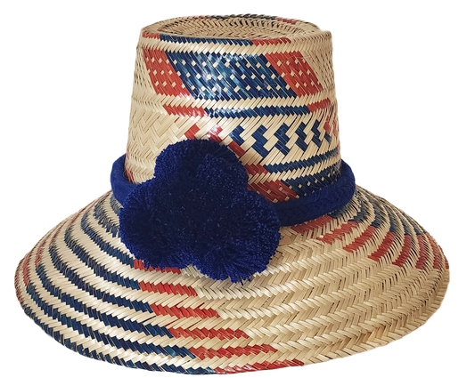 "Handmade Wayuu hat woven from Iraca palm fibers, adorned with colorful pompoms, and adjustable for various sizes."