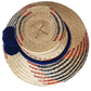 "Handmade Wayuu hat woven from Iraca palm fibers, decorated with colorful pompoms, symbolizing cultural heritage and prosperi