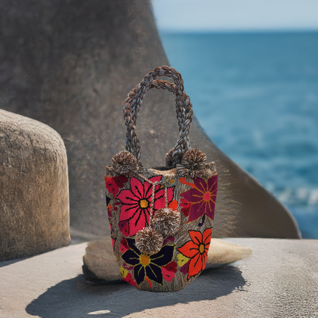 "Handmade Wayuu punch needle bag with colorful intricate designs, short handle, and lined interior, supporting Fair Trade and