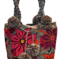 "Handmade Wayuu punch needle bag with colorful intricate designs, short handle, and lined interior, supporting Fair Trade and