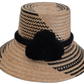 Handmade Wayuu straw hat with subtle black patterns and black pompoms.

