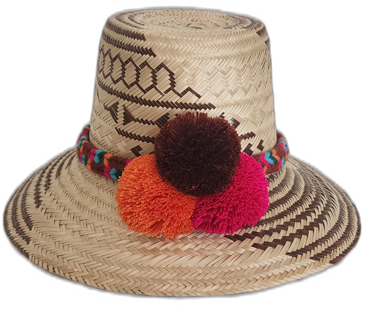 Handmade Wayuu straw hat with brown tribal designs and colorful pompoms