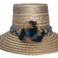 Handmade Wayuu straw hat with a natural Iraca palm weave, decorated with a multicolor braided band and blue, gold, and black pom-poms.
