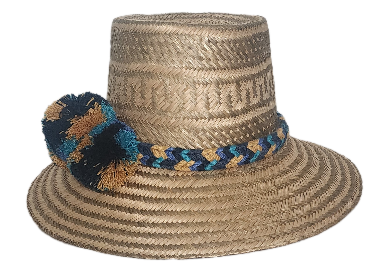 Boho straw hat handcrafted by Wayuu artisans, featuring a bold pom-pom trio in black, teal, and ochre tones, with a matching artisan band.
