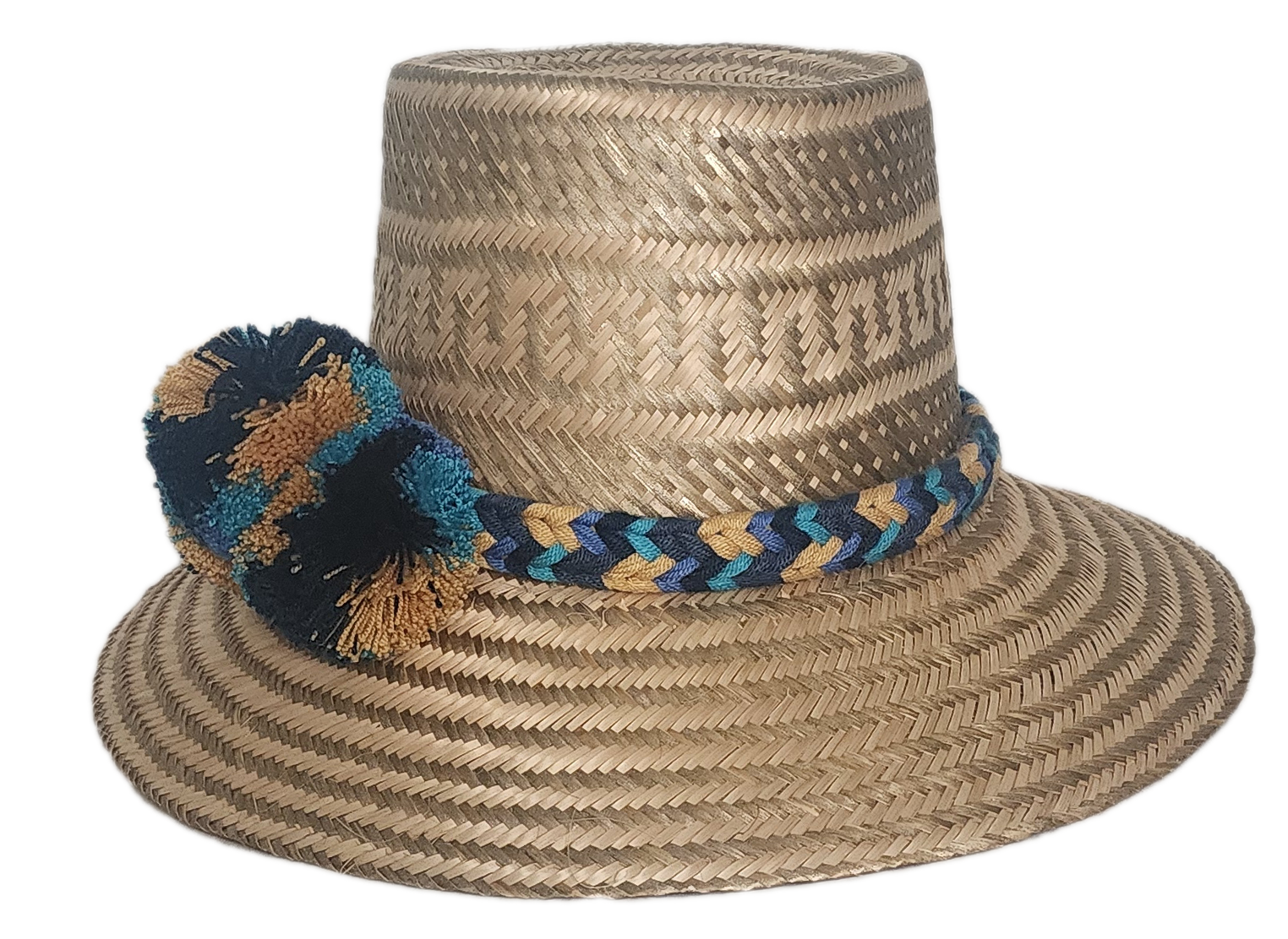 Boho straw hat handcrafted by Wayuu artisans, featuring a bold pom-pom trio in black, teal, and ochre tones, with a matching artisan band.