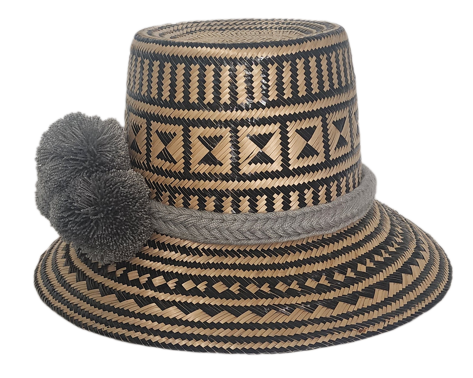 Bohemian artisan straw hat crafted from Iraca palm with black zigzag and diamond patterns, finished with grey pom-poms for a bold yet neutral look.
