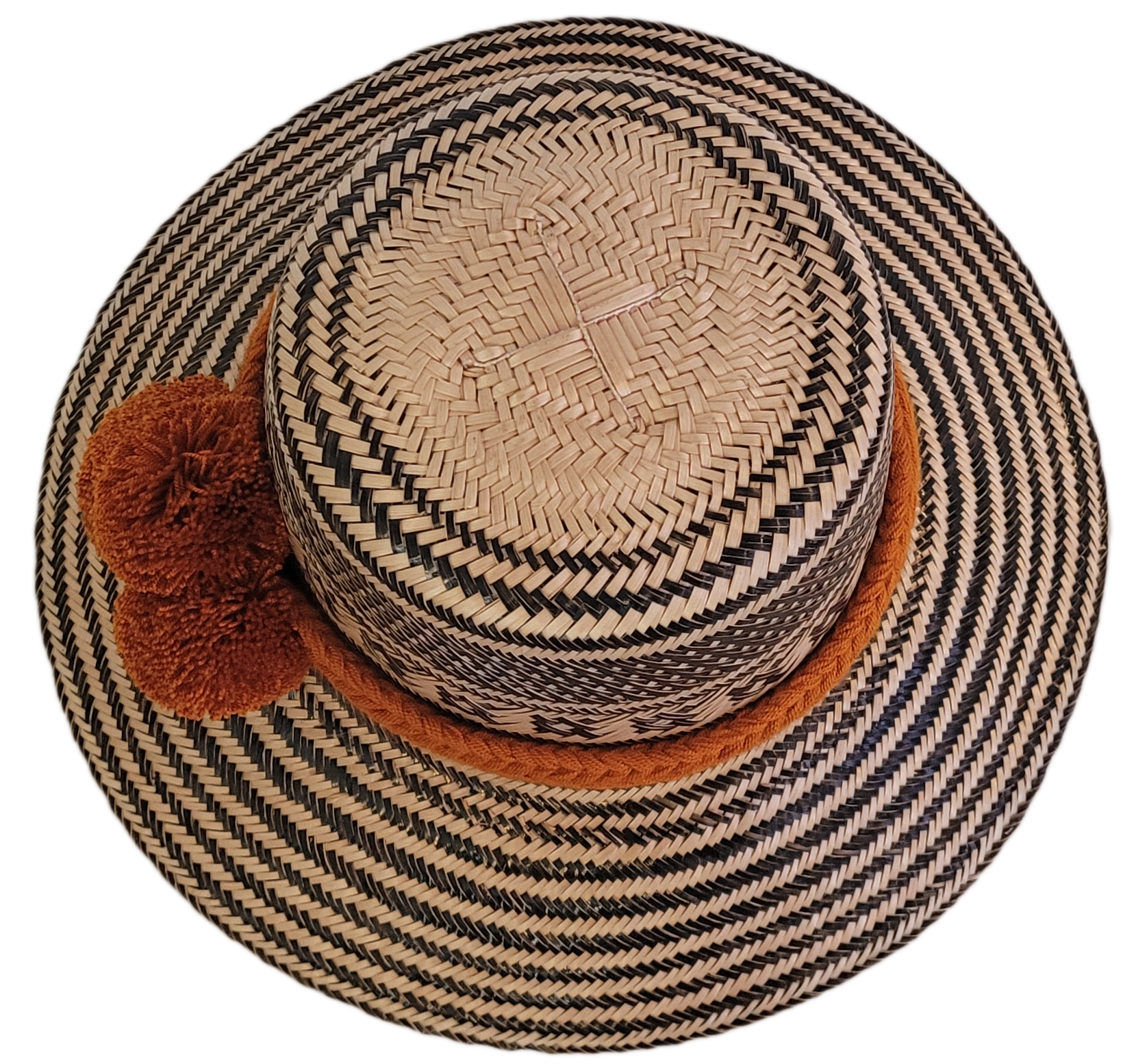 Artisan-crafted Wayuu straw hat with traditional patterns in black, finished with thick orange braided band and handmade pom-poms — perfect bohemian piece.