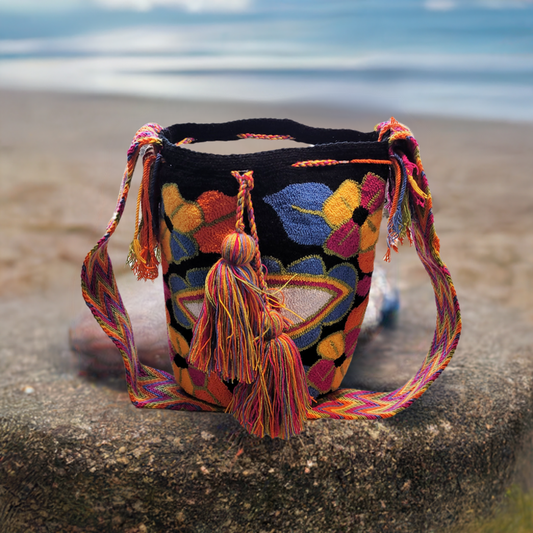 "Handmade Wuitusu Wayuu Bag with vibrant, geometric patterns, adjustable straps, and spacious interior, showcasing Wayuu arti