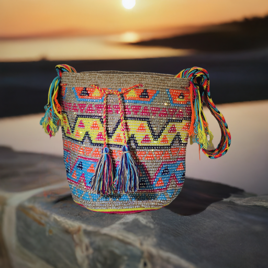 "Handmade Wuitusu Wayuu crochet bag adorned with crystals, showcasing vibrant colors and bohemian charm, supporting Wayuu Tay