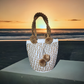 "Handmade Wuitusu Wayuu crochet bag with vibrant patterns, short handle, supporting fair trade and Wayuu community."
