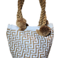 "Handmade Wuitusu Wayuu crochet bag with vibrant patterns, short handle, supporting fair trade and Wayuu community."