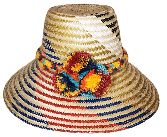 "Handmade Wuitusu Wayuu hat crafted from Iraca palm fibers, adorned with colorful pompoms, reflecting rich Wayuu tribal cultu