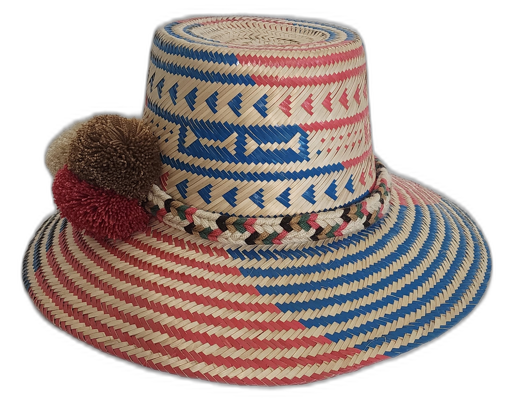 Boho straw hat with bold red and blue patterns, braided band, and colorful pompoms.