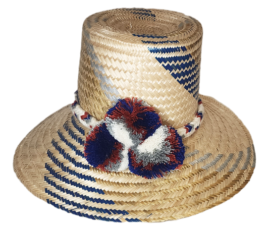 "Handwoven Wayuu hat made from Iraca palm fibers, adorned with colorful pompoms, showcasing artisan craftsmanship and cultura