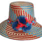 Handmade Wayuu hat with blue and red weave and multicolor pompoms.Boho straw hat with vibrant zigzag design and bold colorful pompoms

