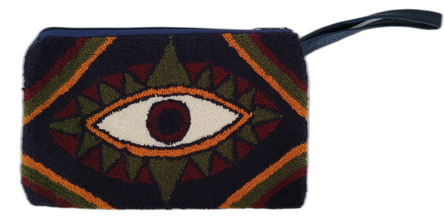 Handmade Wayuu clutch featuring a symbolic eye in boho tribal colors

