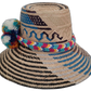 Artisan Wayuu hat Lila with bright pompoms in white, turquoise, yellow, and purple

