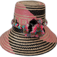 Lilah handmade Wayuu hat with pink, black, and natural palm patterns and vibrant pompoms

