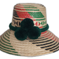 Handmade Wayuu straw hat with red, green, and black weave and green pompoms.Lilliana handmade Wayuu hat with green, red, and black geometric weave and pompoms

