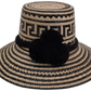Lilly handmade Wayuu straw hat with natural and black palm fiber and large black pompoms

