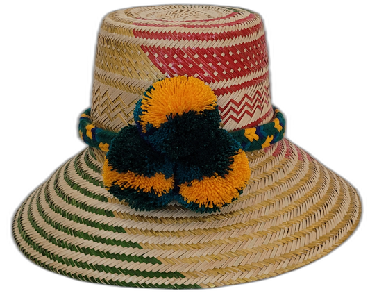 Handmade Wayuu straw hat with red and green weave and yellow pompoms.Boho straw hat with artisan weave and multicolor braided band