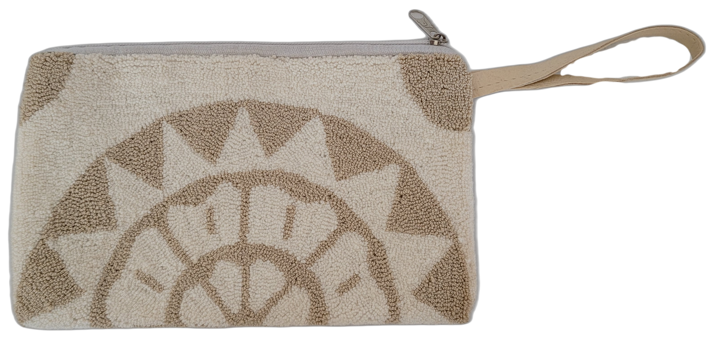 Bohemian punch needle clutch with minimalist sunburst pattern. Handcrafted by Wayuu artisans in cream and beige for timeless, versatile style.