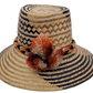 Margo handmade Wayuu straw hat with black and green weave and rust-orange pompoms

