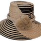 Margot handmade Wayuu straw hat with black geometric weave and beige pompoms


