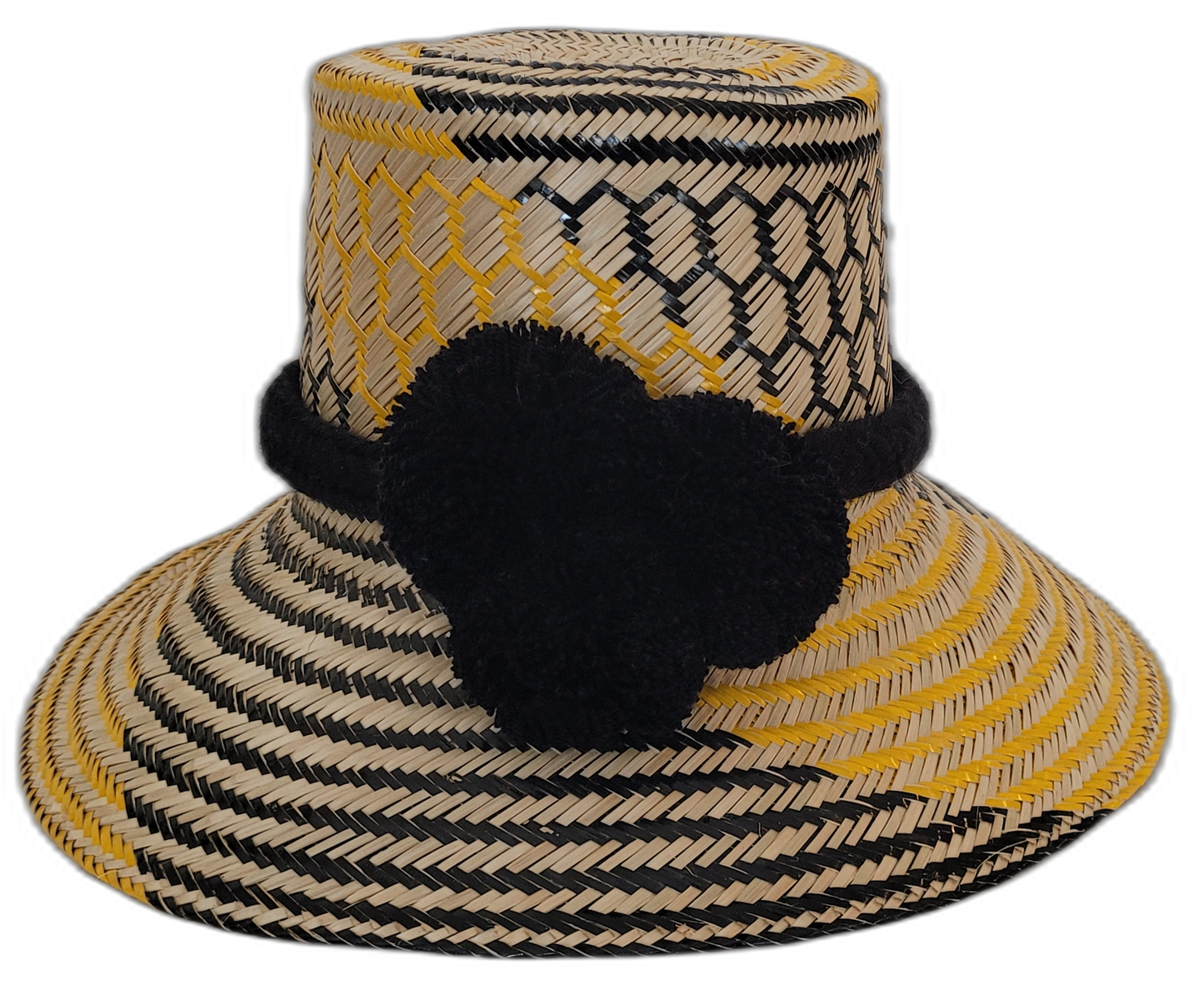 Handmade Wayuu straw hat with black pompoms and bold yellow weave.Artisan straw boho hat with bold black pompoms and geometric design

