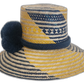 Colorful Boho Chick straw hat featuring traditional Wayuu patterns and navy pompoms.Natural straw hat with navy and yellow stripes and handmade blue pompoms

