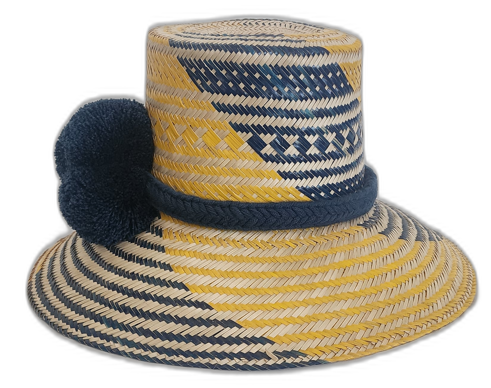 Colorful Boho Chick straw hat featuring traditional Wayuu patterns and navy pompoms.Natural straw hat with navy and yellow stripes and handmade blue pompoms

