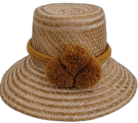 Handmade minimalist natural Wayuu hat with bold ochre pompoms.

