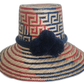 Boho Straw Hat with navy pompom, handmade by Wayuu artisans in red, blue, and natural straw