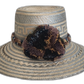 Handmade Wayuu straw hat in earth tones with soft pompom accents

