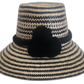 Handmade Wayuu straw hat in black and natural with decorative pompoms