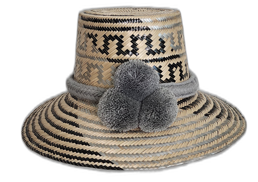 Handmade Wayuu straw hat in grey and black with matching grey pompoms.Bohemian artisan hat with soft gray pompom trio and handcrafted weave