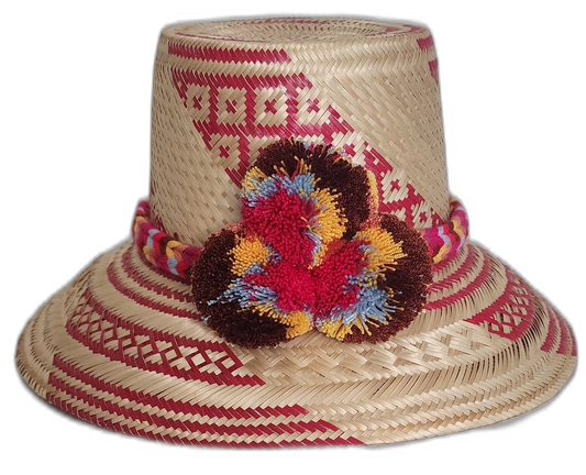 Handmade Wayuu straw hat with red patterns and vibrant pompoms