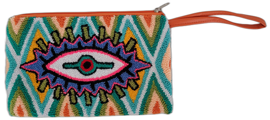 The Reign clutch is a bold punch needle Wayuu creation with vibrant colors and eye motif. Handmade, colorful, and fully lined for boho chic lovers.

