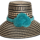 Handmade Wayuu straw hat with black weave and turquoise pompoms.Rose handmade Wayuu hat with black stripe pattern and turquoise pompoms

