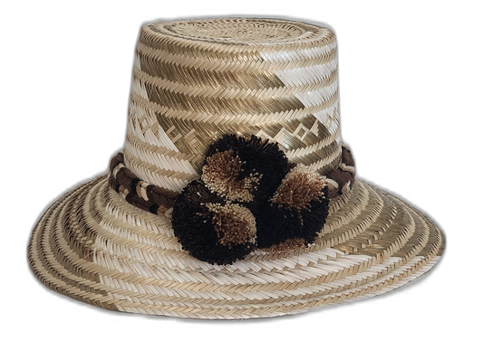 Minimalist boho hat in natural straw with soft earthy tones and handcrafted pompom accents

