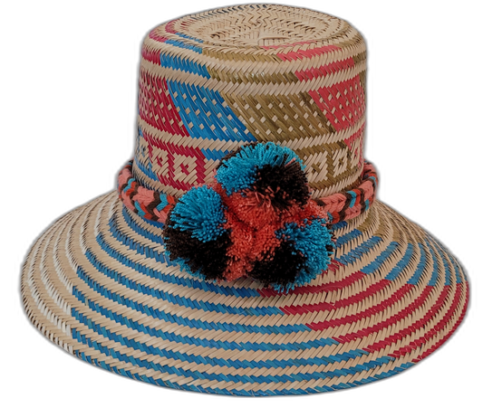 Selena handmade Wayuu hat with natural, red, blue, and black palm weave and pompoms

