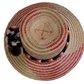 Wayuu bohemian straw hat with bold red accents and traditional pompom decor