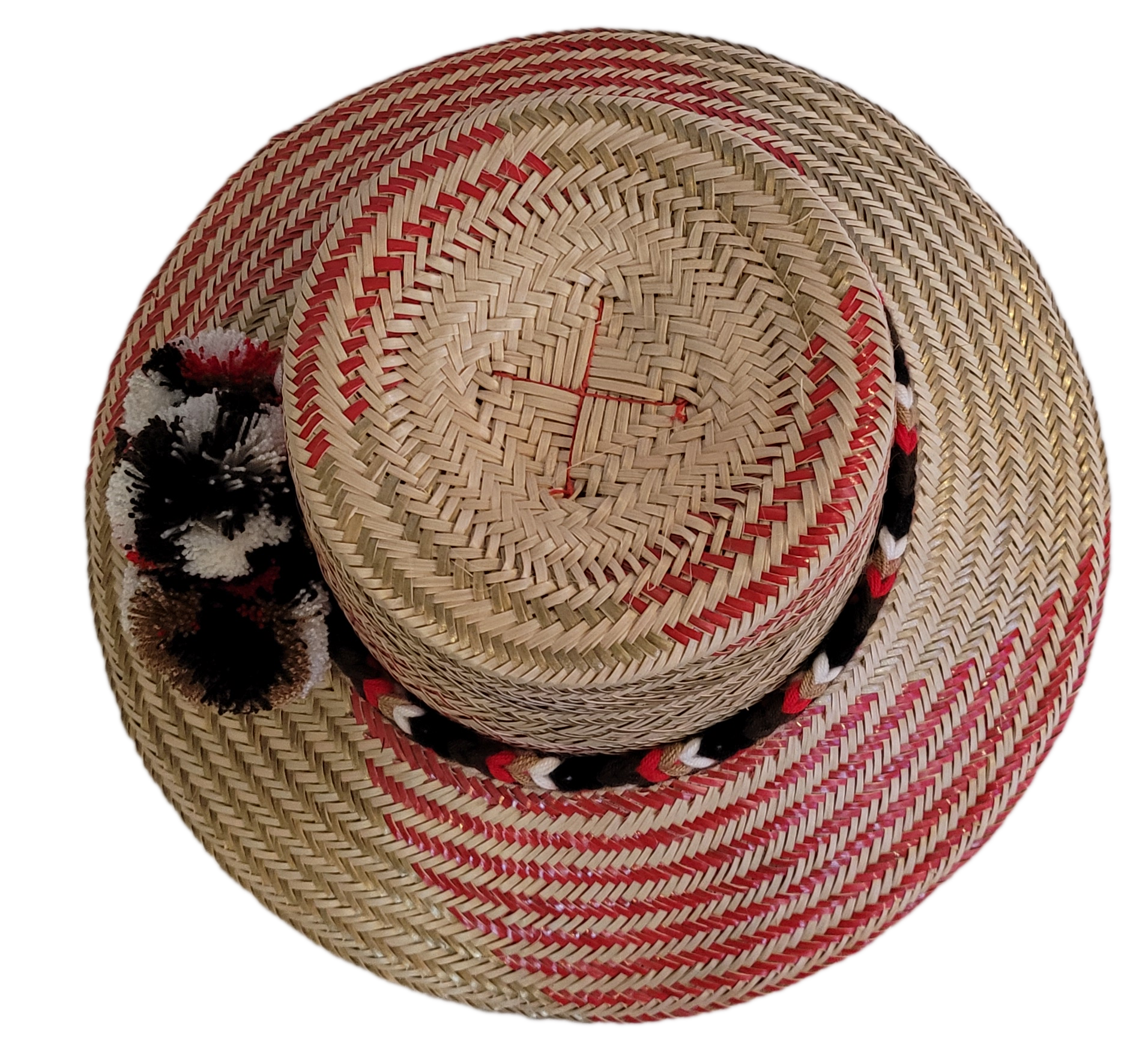 Wayuu bohemian straw hat with bold red accents and traditional pompom decor