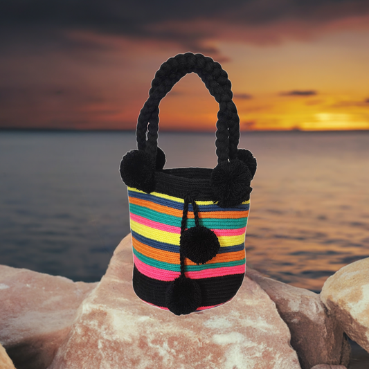 Boho-chick Wayuu crochet bag with black pompoms and rainbow stripes