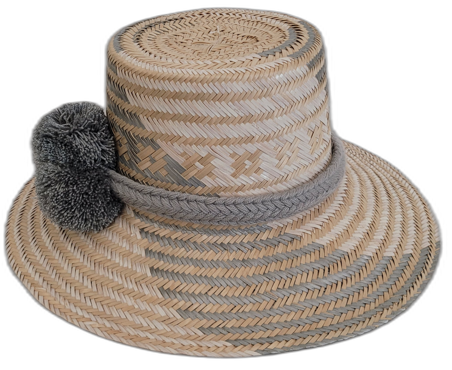 Artisan-crafted Wayuu straw hat in natural and gray, accented with gray pompoms.

