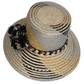 Artisan Wayuu hat featuring neutral palette, braided band, and bold pompoms.