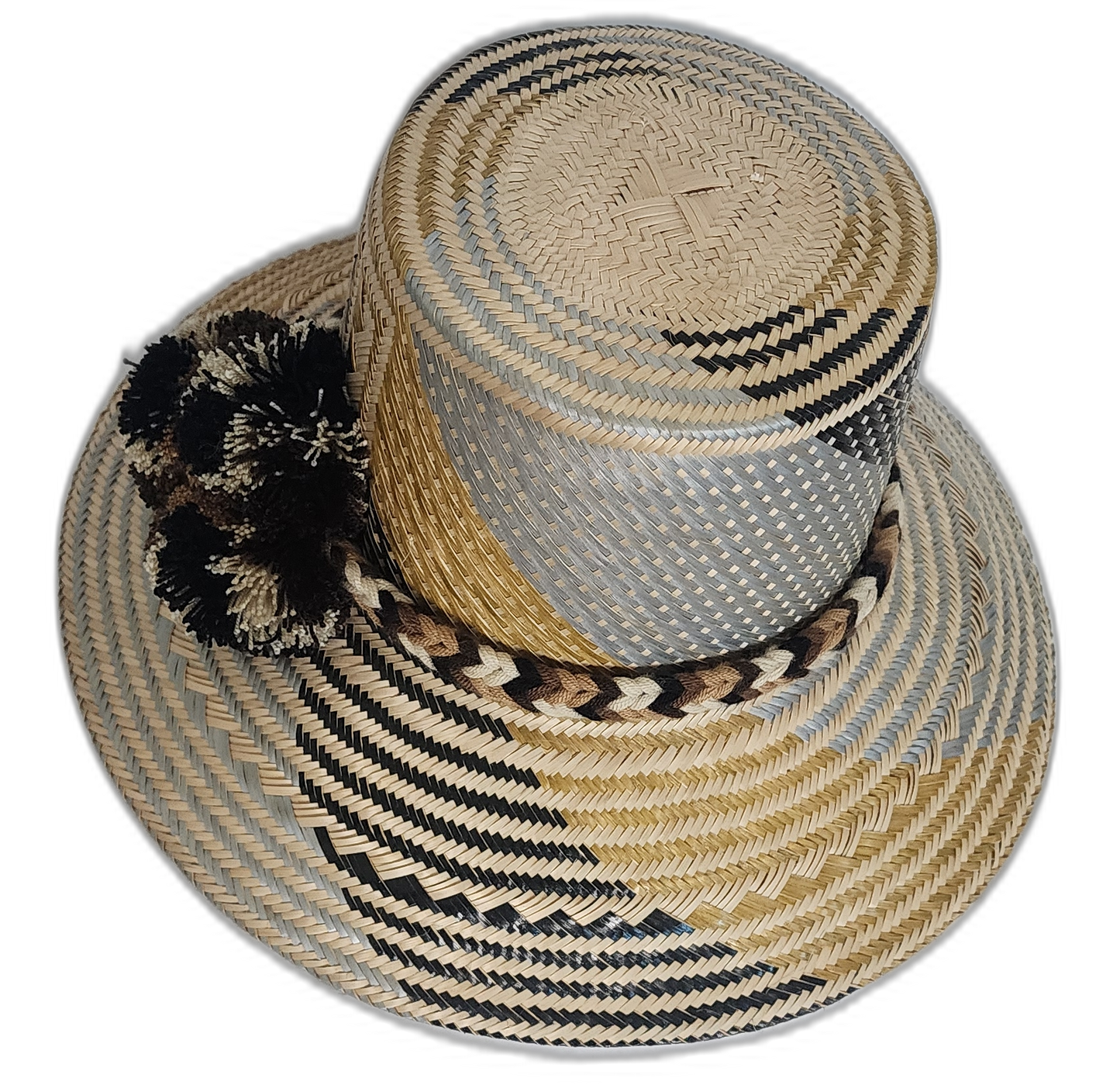 Artisan Wayuu hat featuring neutral palette, braided band, and bold pompoms.
